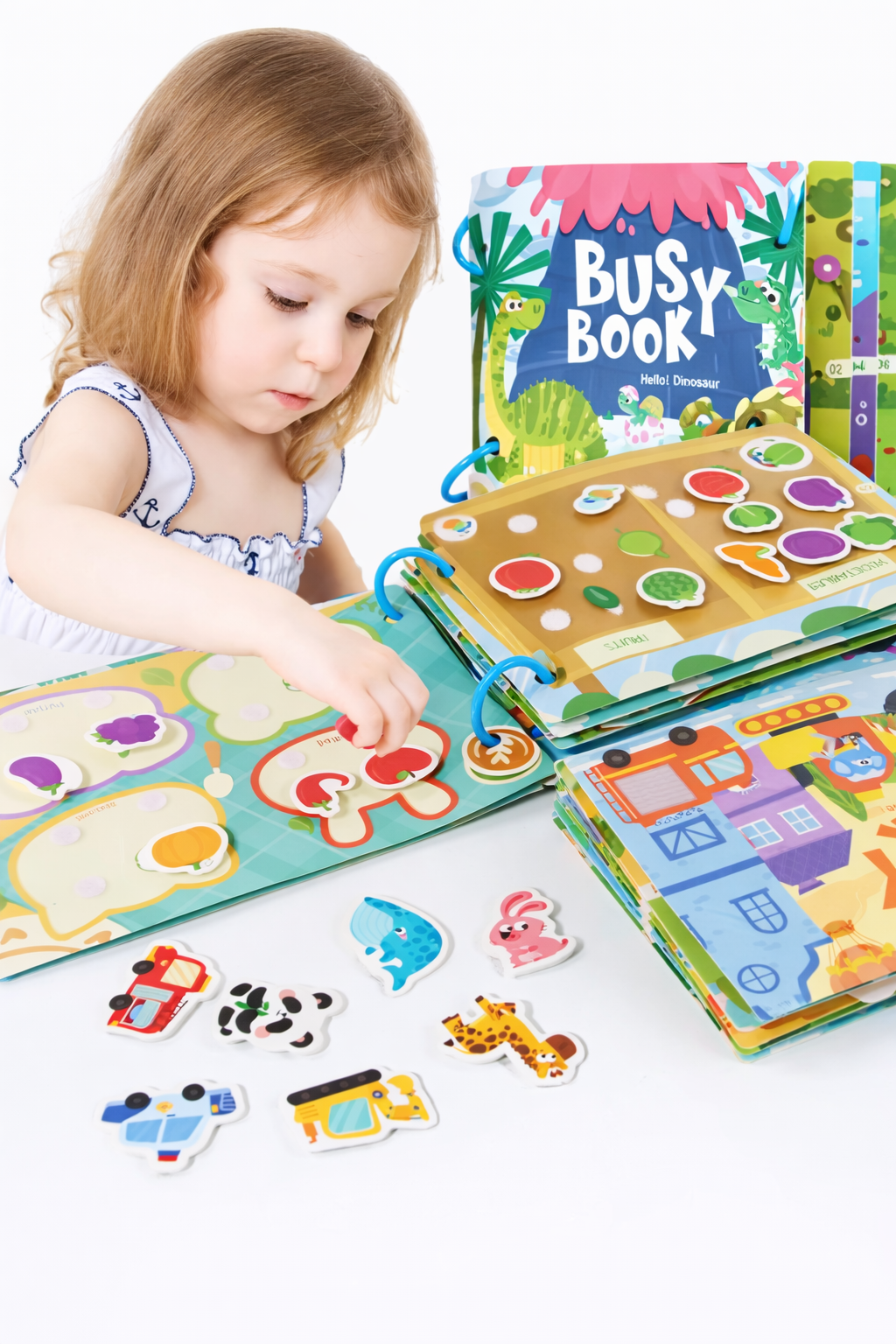 Child playing with a Busy Book on a white surface
