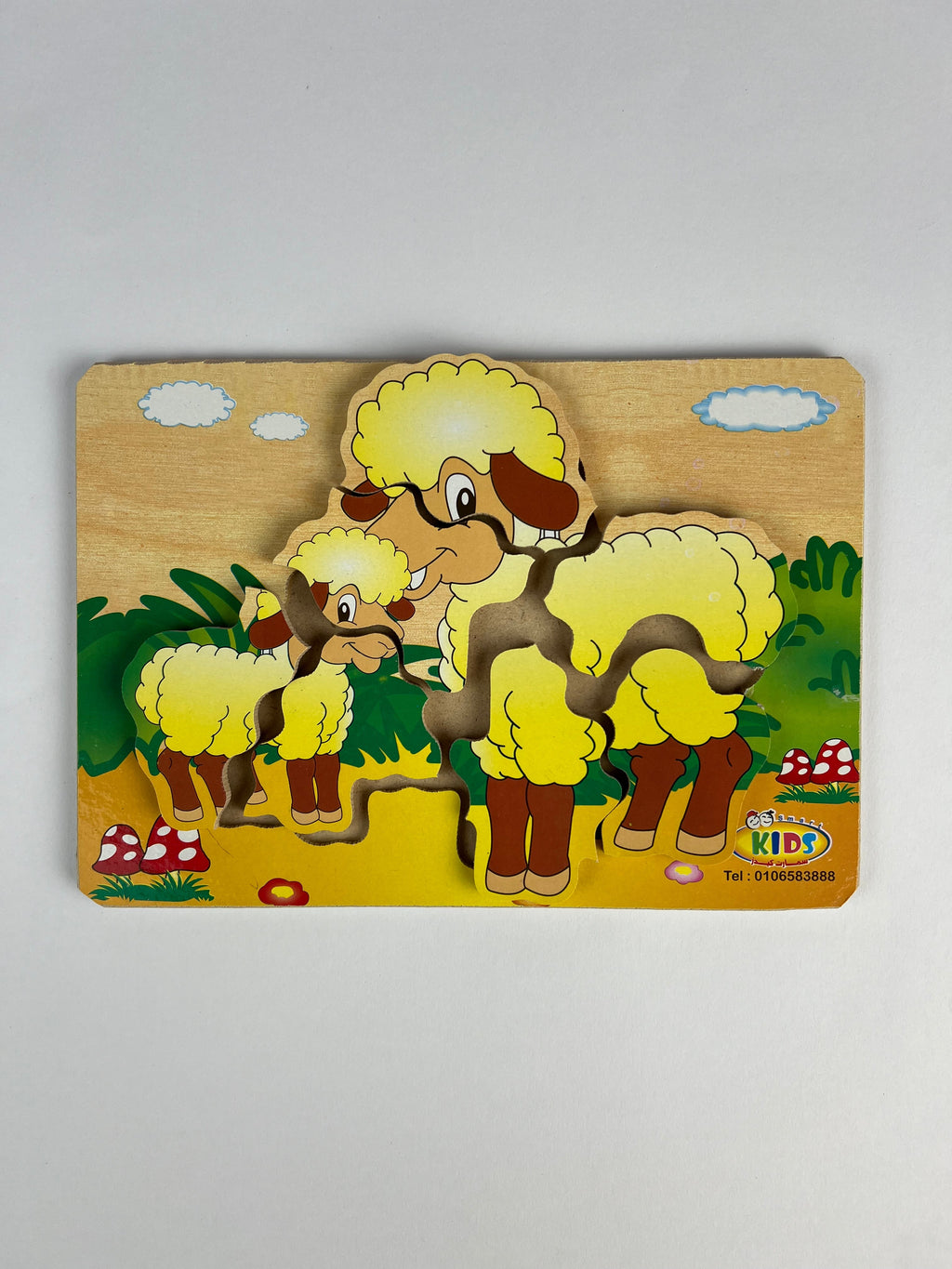 Wooden puzzle with cartoon sheep design on a gray background