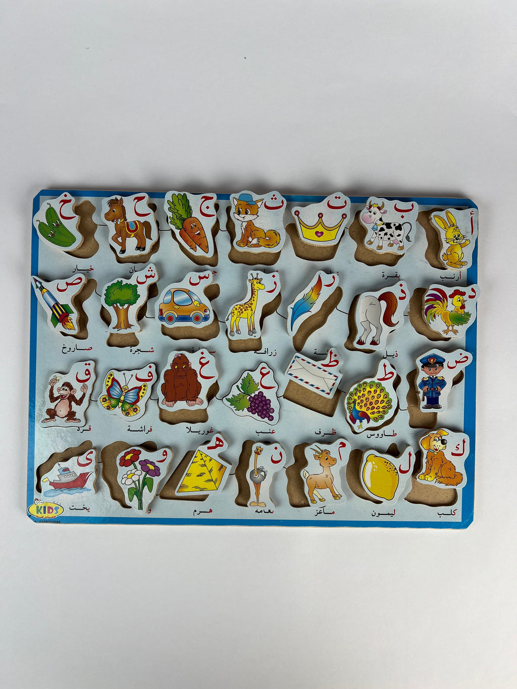 Wooden puzzle with animal and object shapes on a white background