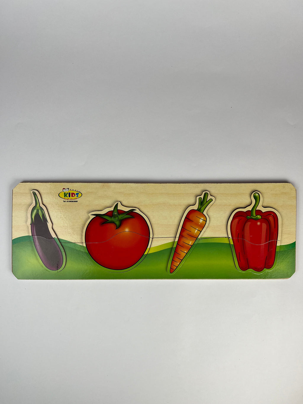 Wooden puzzle with colorful vegetables on a gray background