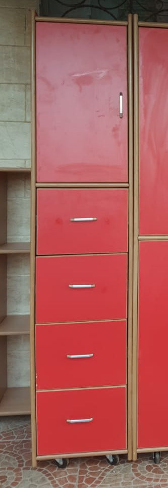 Red storage unit with multiple doors and drawers in a room setting.